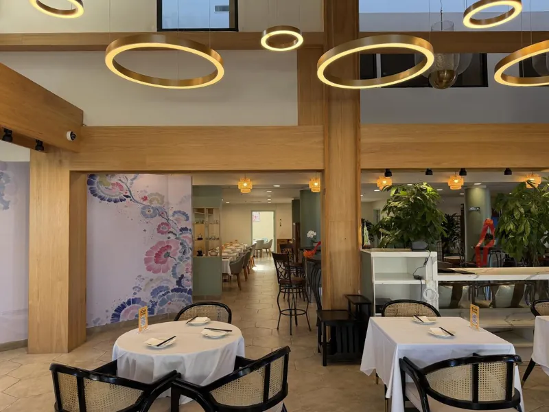 Elegant dining area with round tables and modern lighting at Linglong, a Chinese Restaurant in Fountain Valley.
